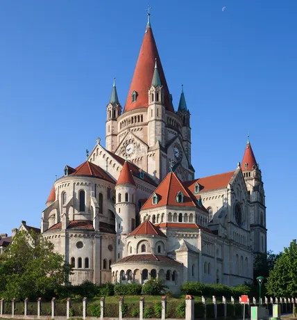 St. Francis of Assisi Church in Vienna with red roofs and blue sky, a potential Austrian Post stamp motif.