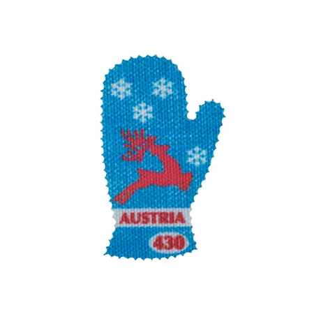 Briefmarke Österreich 2023, Nominale 4,30 Euro: Handschuhform mit rotem Rentier und Schneeflocken.