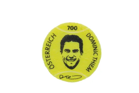 Yellow tennis ball-shaped stamp with the text &quot;Dominic Thiem&quot; and his portrait. Nominal value: 700, Austria, 2023